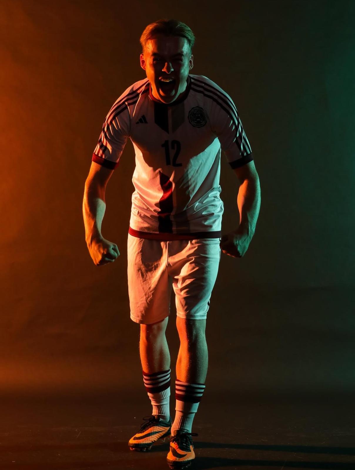 SAGA player in a studio portrait celebrating